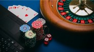 Playing cards arranged on a wooden table, representing a classic casino card game and online betting strategy concept.
